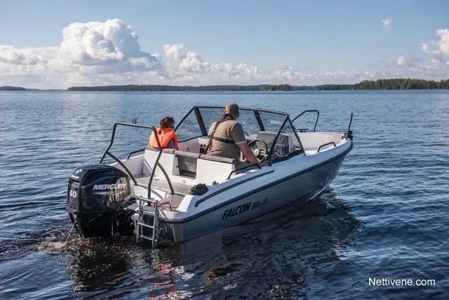 Two people in a boat on a lake, wearing life jackets, with a Mercury outboard motor, under a cloudy sky.